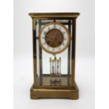 A MID 19TH CENTURY FRENCH BRASS AND GLASS MANTEL CLOCK the white enamel dial with Arabic numerals,