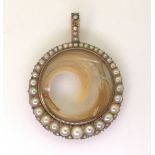 A VICTORIAN PEARL SET LOCKET the rose-coloured mount with double sided glazed panel containing two