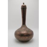 A PERSIAN BRASS BALUSTER VASE AND COVER  decorated allover with scrolling foliage and with raised