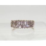 AN 18CT ETERNITY RING An 18ct white gold baguette and brilliant cut half eternity ring, set with