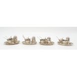 A CHINESE SILVER CRUET SET Decorated with bamboo, comprising; four saucers, 8.5cm diameter, four