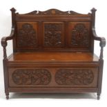 AN EARLY 20TH CENTURY SCOTTISH HALL SETTLE  with three panel back rest carved with thistle motifs