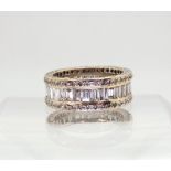 A FULL DIAMOND ETERNITY RING mounted throughout in 18ct white gold. Centrally set with baguette