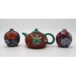 A CHINESE YIXING TEAPOT of gourd form, decorated and enamelled in relief with foliage and birds,