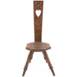 AN EARLY 20TH CENTURY CARVED OAK SPINNING CHAIR  back rest pierced with heart shaped decoration over