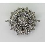 A VICTORIAN PENDANT BROOCH the diamond flower, is set with old cut diamonds to the white metal