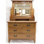 AN OAK ARTS & CRAFTS DRESSING CHEST with moulded cornice top over stylised pierced top rail