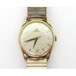 A GENTS 9CT GOLD OMEGA the silvered dial has gold baton numerals and dauphin hands, the movement