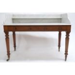 A VICTORIAN MAHOGANY BASED MARBLE TOPPED WASHSTAND  with marble galleried back top over two