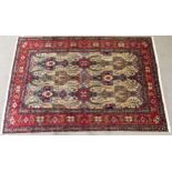 A CREAM GROUND TABRIZ RUG with all-over multicoloured floral geometric design and red flower head