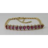 A RUBY AND DIAMOND BRACELET the gem set panel has marquis cut rubies of approx 5mm x 2.5mm and eight