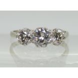 A CLASSIC THREE STONE DIAMOND RING the white metal shank stamped 750. with the three diamonds set