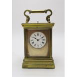 A LATE 19TH CENTURY GILT BRASS AND GLASS REPEATING CARRIAGE CLOCK  the white dial with roman