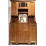 AN AUSTRIAN SECESSION STYLE OAK SIDEBOARD  with moulded cornice over central bevelled glass door and