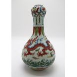 A CHINESE WUCAI GARLIC NECK VASE decorated with dragons amongst clouds and waves chasing flaming