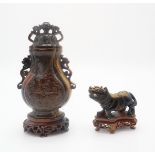 A CHINESE TIGER EYE VASE AND COVER Carved in the Archaic style, wood stand, 17.5cm high, overall and