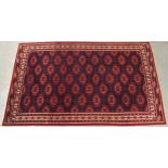 A DARK BLUE GROUND TURKMAN RUG with all-over geometric lozenge design and multicolour geometric