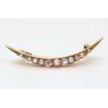 CRESCENT MOON BROOCH the bright yellow galleried mount is set with old cut diamonds and pearls, with