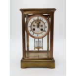 A LATE 19TH CENTURY FRENCH BRASS AND GLASS MANTEL CLOCK the white enamel dial with roman numerals