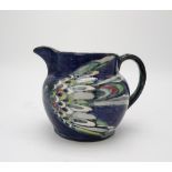 ELIZABETH MARY WATT (SCOTTISH 1886-1954) A bird painted jug with dark blue ground, signed EM Watt,