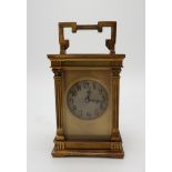 A FRENCH BRASS AND GLASS CARRIAGE CLOCK the silvered dial with Arabic numerals, the case with an