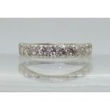 A HALF ETERNITY RING the 18ct white gold shank set with ten brilliant cut diamonds, with an