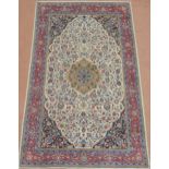 A CREAM FLORAL PATTERNED GROUND SAROUGH RUG  with mustard central medallion, dark blue spandrels and