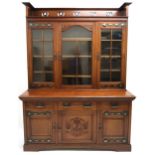 A LATE VICTORIAN MAHOGANY ARTS & CRAFTS BOOKCASE  with pierced gallery top over three beaded glass