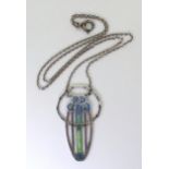 A GLASGOW GIRLS PENDANT in white metal and champlevé enamelled with Mackintosh style roses in