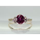 A VINTAGE RING set with diamonds and a faux purple sapphire, mounted in bright yellow and white