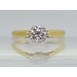 A DIAMOND SOLITAIRE set in 18ct yellow and white gold with classic crown mount set with an estimated
