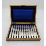 A CASED SET OF EDWARDIAN SILVER MOTHER OF PEARL FISH KNIVES AND FORKS the blades by Fenton Brothers,