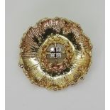 A 9CT GOLD BROOCH in the shape of a poppy, set with four diamonds with a combined estimate of 0.
