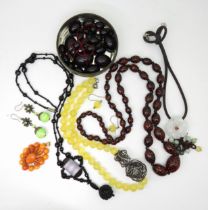 A string of unusual black and red millefiori Murano beads, a n amber brooch (af) a partial string of