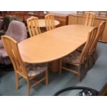 A 20th century Danish teak Skovby dining suite consisting oval extending dining table with