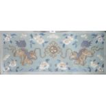 A Chinese silk panel, depicting a pair of Kylin on a blue ground surrounded by bats and flowers,