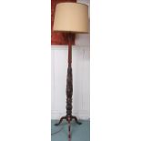 A 20th century standard lamp carved with spiralling acanthus leaves on tripod base, 189cm high