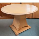 A contemporary teak and birdseye maple drop side circular topped table, 74cm high x 110cm diameter