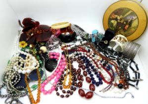 A string of cherry amber coloured beads, a string of garnet beads and a collection of further