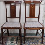 A pair of late Victorian mahogany framed Art Nouveau chairs with pierced samplewood inlaid back