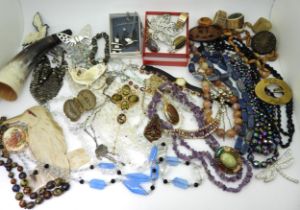 A Max Neiger style Buddha brooch, peacock beads, a collection of horn brooches, and other items