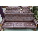 A Norwegian Ekornes stained teak framed three piece suite with buttoned brown leather upholstery
