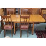 A 20th century oak extending dining table with two internal leaves on pair of trestle supports