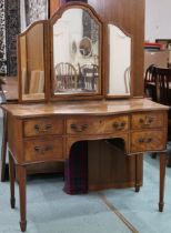 A 20th century mahogany serpentine front mirror backed dressing table, 149cm high x 113cm wide x