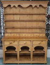 A 20th century pine Welsh style kitchen dresser with open plate rack on base with three drawers over