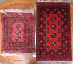 A lot comprising red ground Bokhara rug, 92cm long x 53cm wide and another smaller example, 61cm