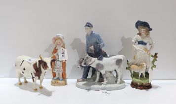 A Royal Copenhagen figure of a boy and two calf's, a Beswick bull Whitehill Mandate, and two other