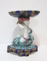 A large majolica style centrepiece, modelled as two maidens supporting s shell, together with