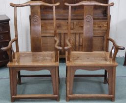A pair of 20th century Chinese Jichimu "wing wood" yoke back open armchairs with scrolled arms over