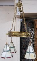 An early 20th century brass ceiling light fixture with four leaded stained glass shades, approximate